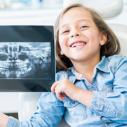 Young girl holding her x-rays