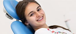 Smiling woman in orthodontist's chair